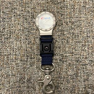 Crest toothpaste, watch with compass and a key ring